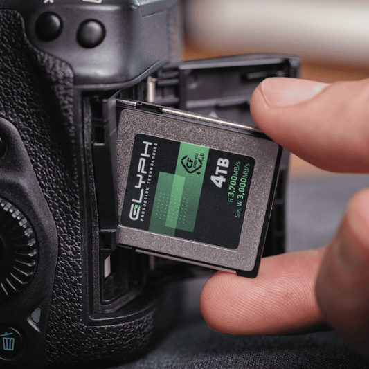 Person inserting a 4TB Glyph CFexpress memory card into a camera
