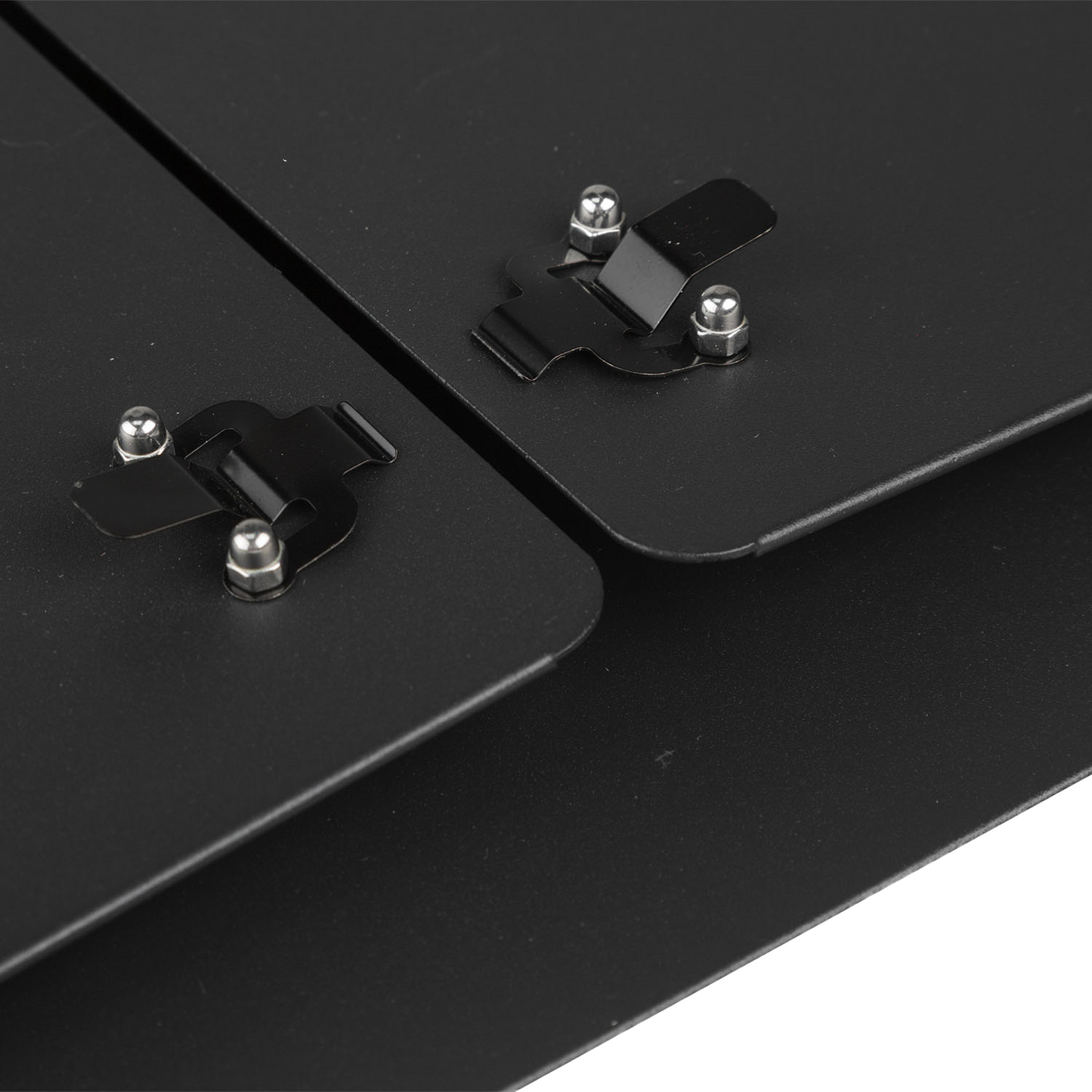 Close-up of black metal brackets on a black surface