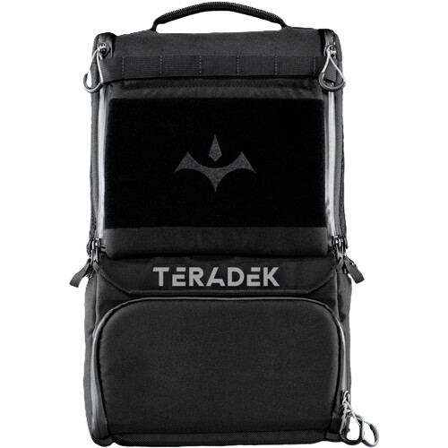 A black Teradek Prism backpack shown from the front against a plain white background, featuring a top handle, multiple zippered compartments, and a silver brand logo and name on the front.