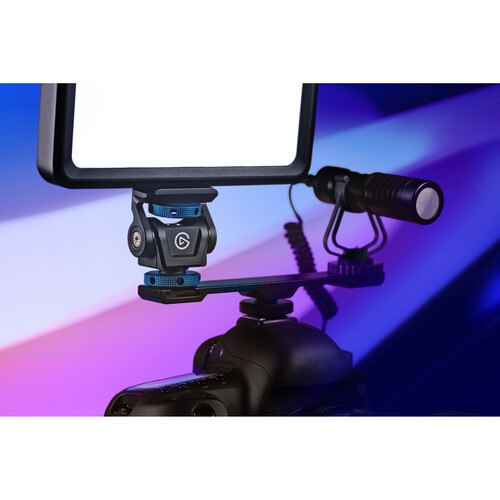 Camera setup with light and microphone on a colorful background
