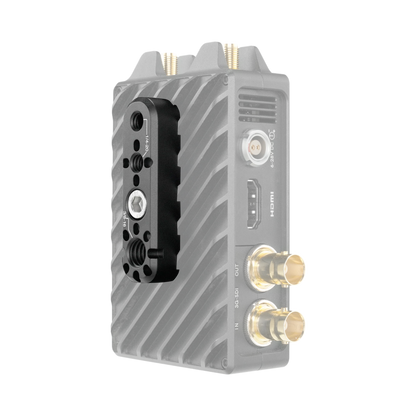A compact electronic device with a ribbed gray body, a black mounting plate on the front, and multiple gold-plated connectors, shown on a plain white background.