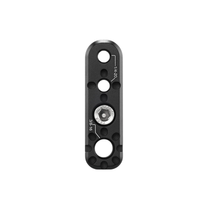 A black anodized aluminum quick-release camera lens clamp with a central silver hex socket and white technical specifications printed on the surface, shown against a plain white background.
