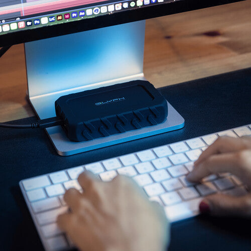 Person using a computer with a keyboard and monitor on a desk