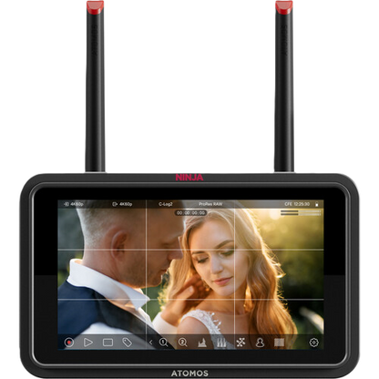 ATOMOS NINJA TX GO video monitor displaying a couple in an outdoor setting with antennas on top.