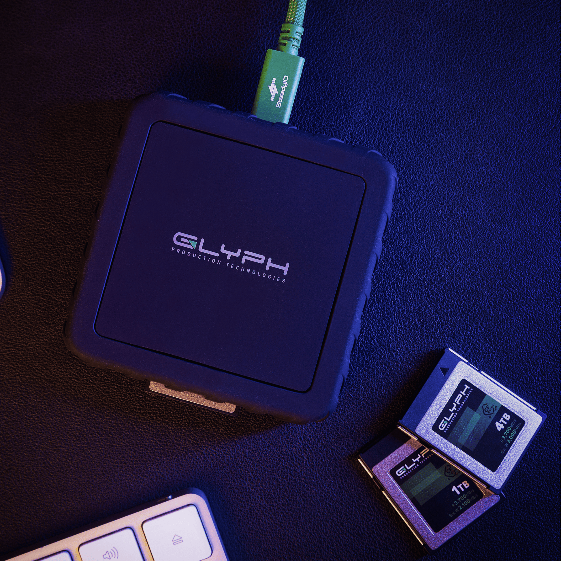 Glyph Capture+ CFexpress Type B USB4 Memory Card Reader with CFexpress memory cards on desk