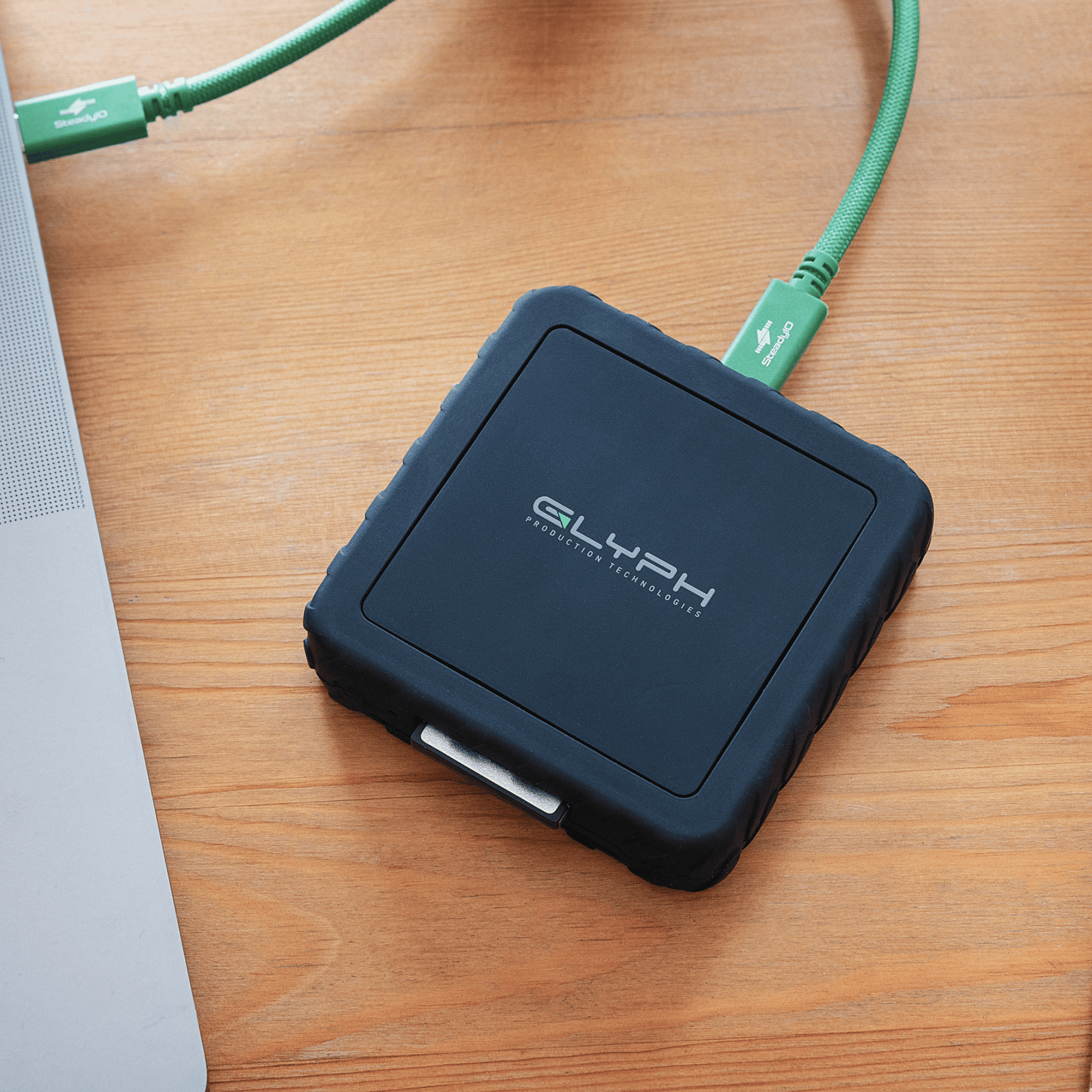 Glyph Capture+ CFexpress Type B USB4 Memory Card Reader on wooden desk