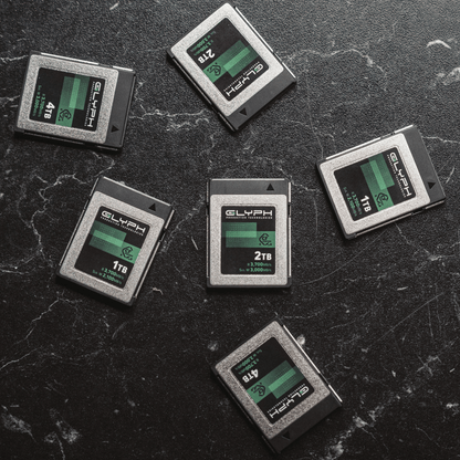 Glyph CFexpress memory cards on a textured black surface