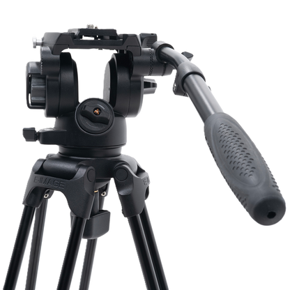 Black camera tripod with head on a white background
