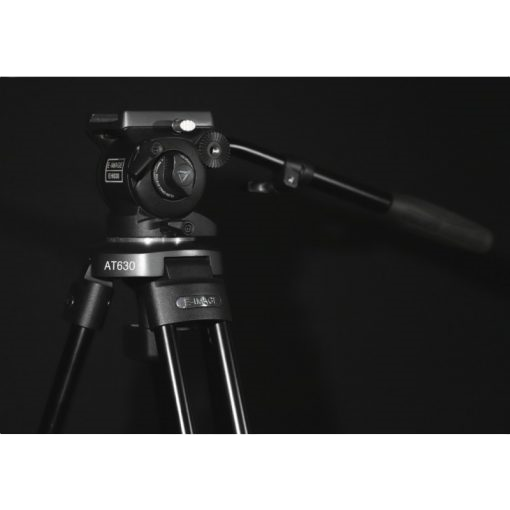 Camera tripod with head on a black background