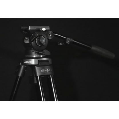 Camera tripod with head on a black background