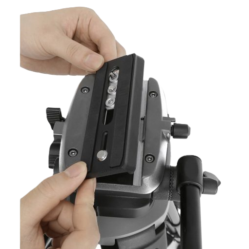 Close-up of a person adjusting a camera mount on a tripod with a white background