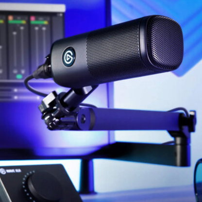 Black microphone on a stand with blurred audio equipment in the background