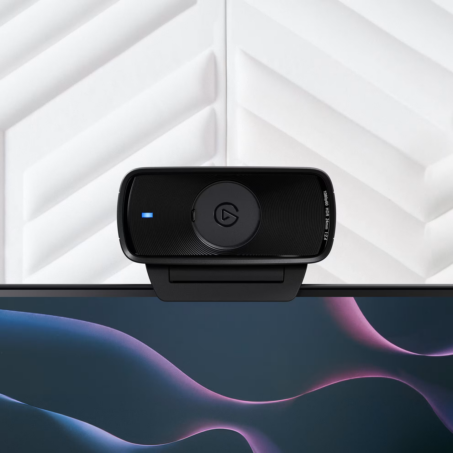Black webcam on a computer monitor with a white geometric background