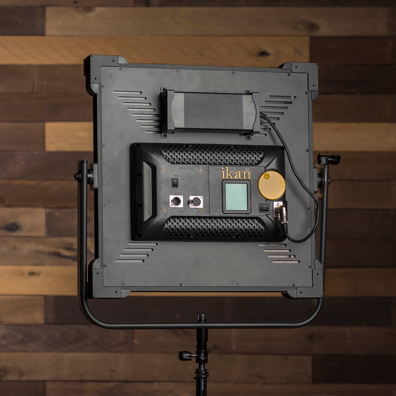 Ikan LED light panel on a stand against a wooden background