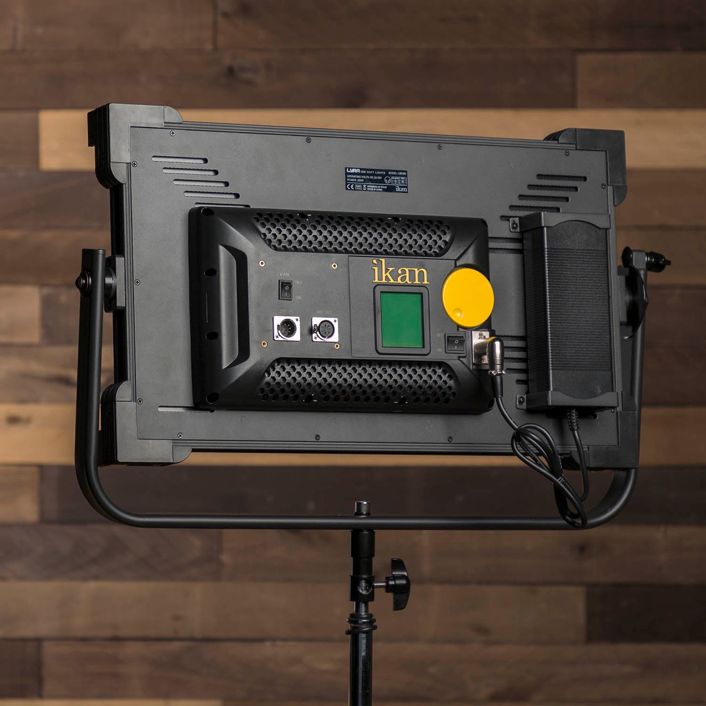 Studio light with 'ikan' branding on a wooden background