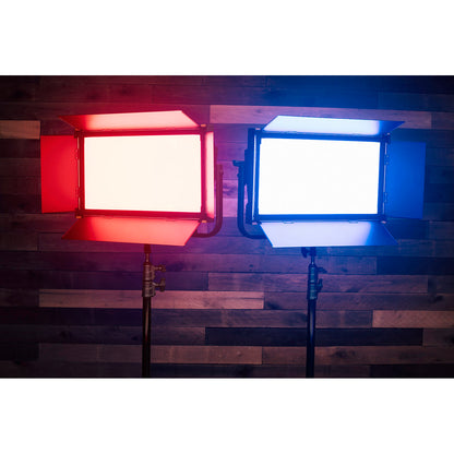 Two studio lights, one red and one blue, on a wooden floor.