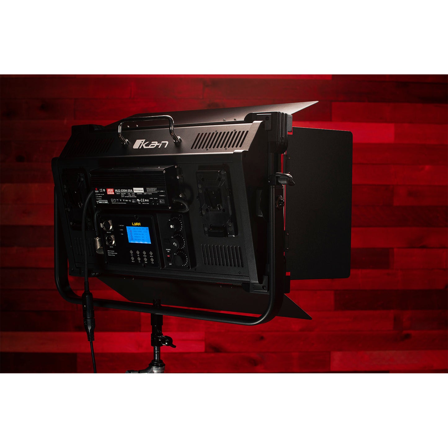 Black studio light with brand logo on a red background