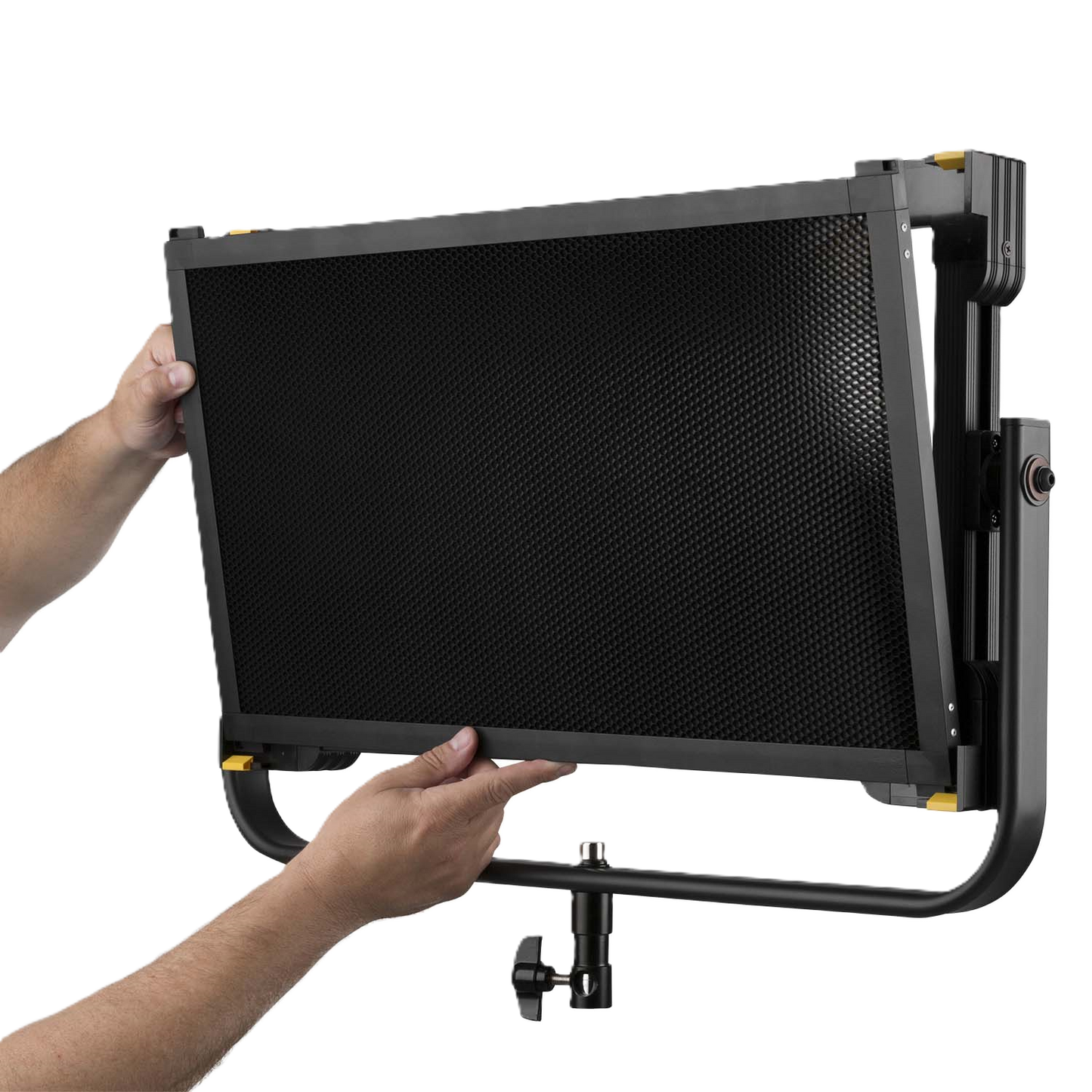 Person holding a large black screen with a grid pattern on a white background