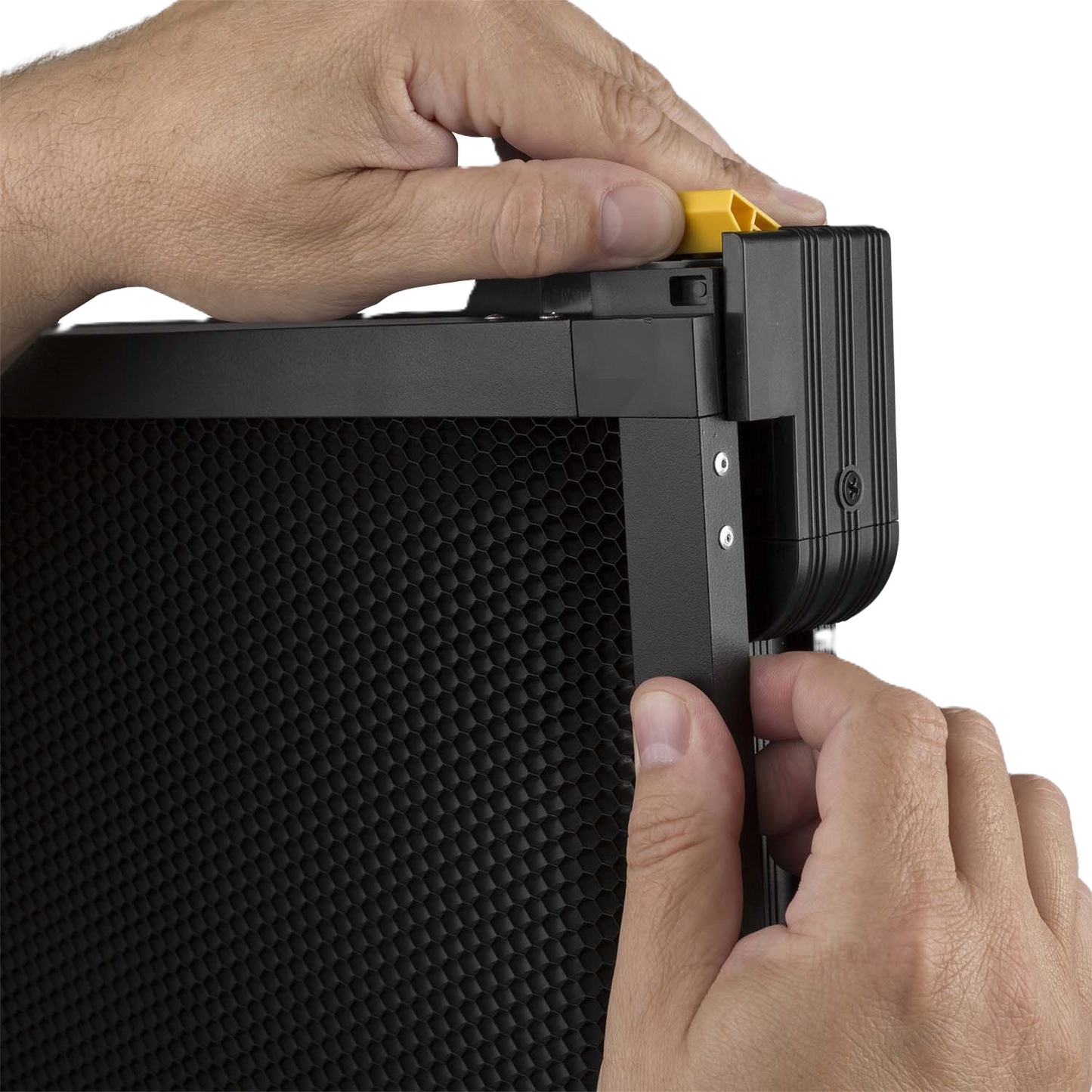 Close-up of hands attaching a black electronic device with textured surface
