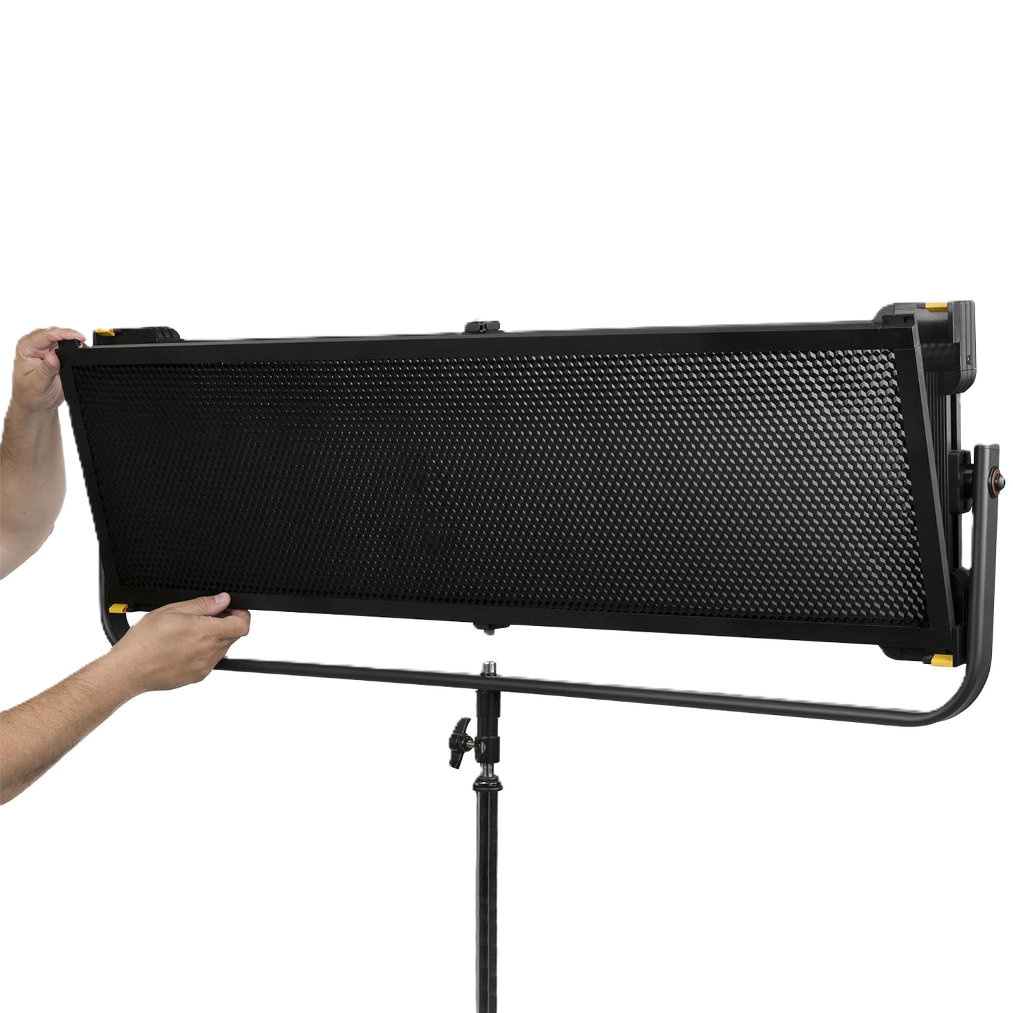 Person holding a large black light panel on a stand against a white background