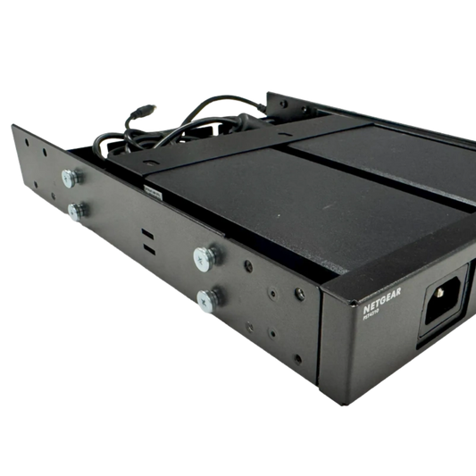 A black metal mounting bracket or enclosure component with visible screws, cables, and a power connector, photographed on a plain white background. The brand name NETGEAR is printed on the side.