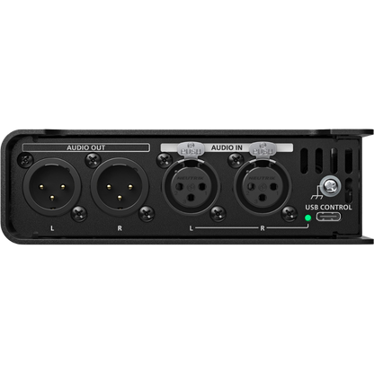 Black audio interface with multiple ports on a white background