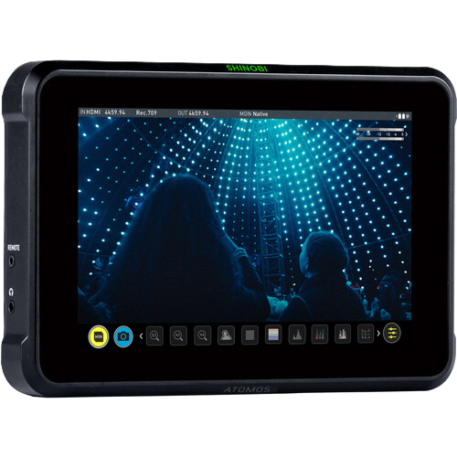 Display device with screen showing a silhouette of people in front of a bright light display, branded 'Atomos'.