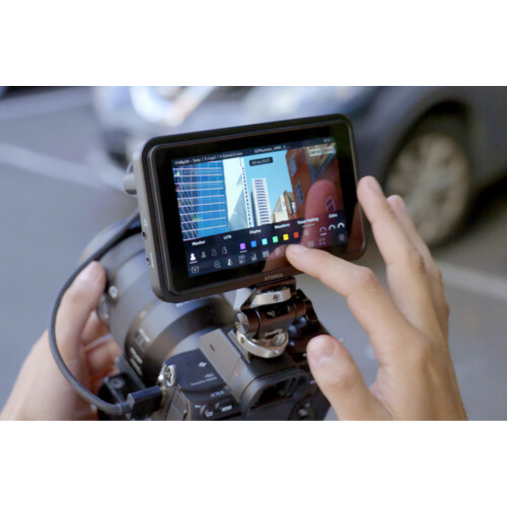 Person using a smartphone with a screen overlay on a camera, likely for photo or video editing.