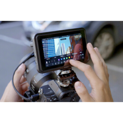 Person using a smartphone with a screen overlay on a camera, likely for photo or video editing.