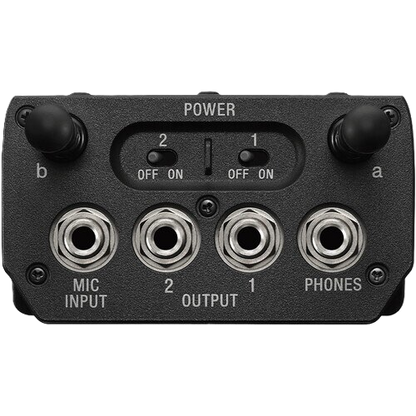 Black audio interface with power switch, input/output ports, and labels on a white background